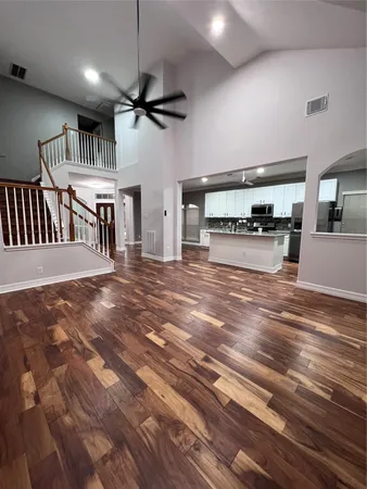 a view of a living room a ceiling fan and windows