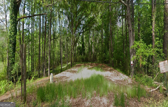 a backyard of a house with lots of green space and fountain