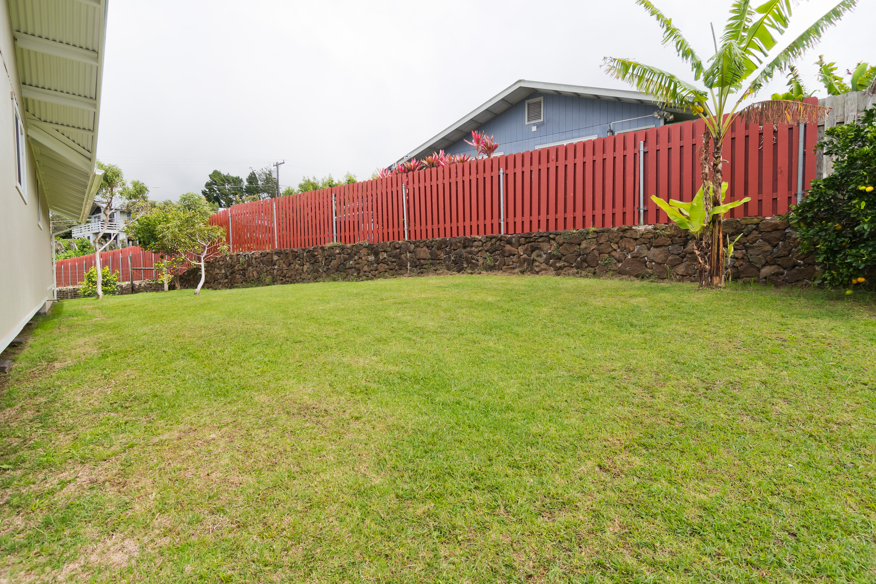 64-5246 Puu Nani Drive Kamuela, HI 96743 - Photo 20 of 25 a view of a backyard with potted plants and wooden fence