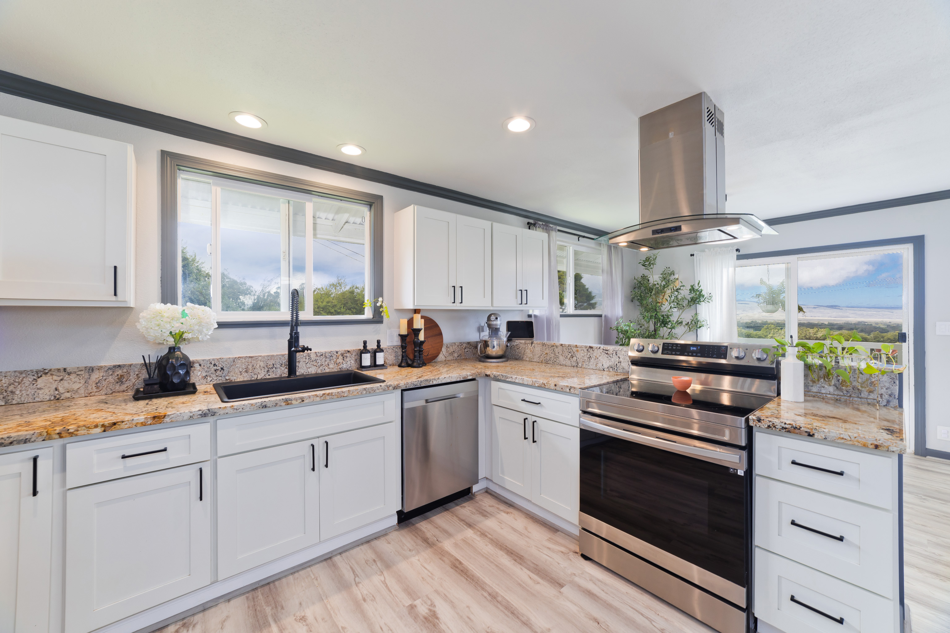 64-5246 Puu Nani Drive Kamuela, HI 96743 - Photo 5 of 25 a kitchen with stainless steel appliances granite countertop white cabinets and window