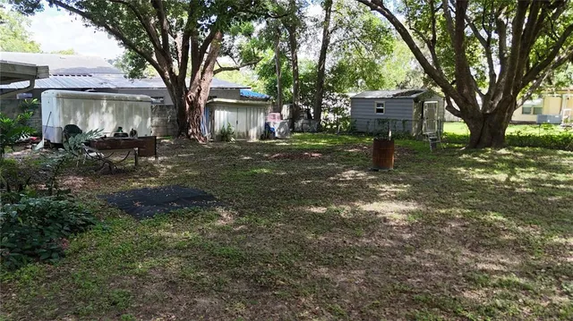 a view of a house with a tree in the yard