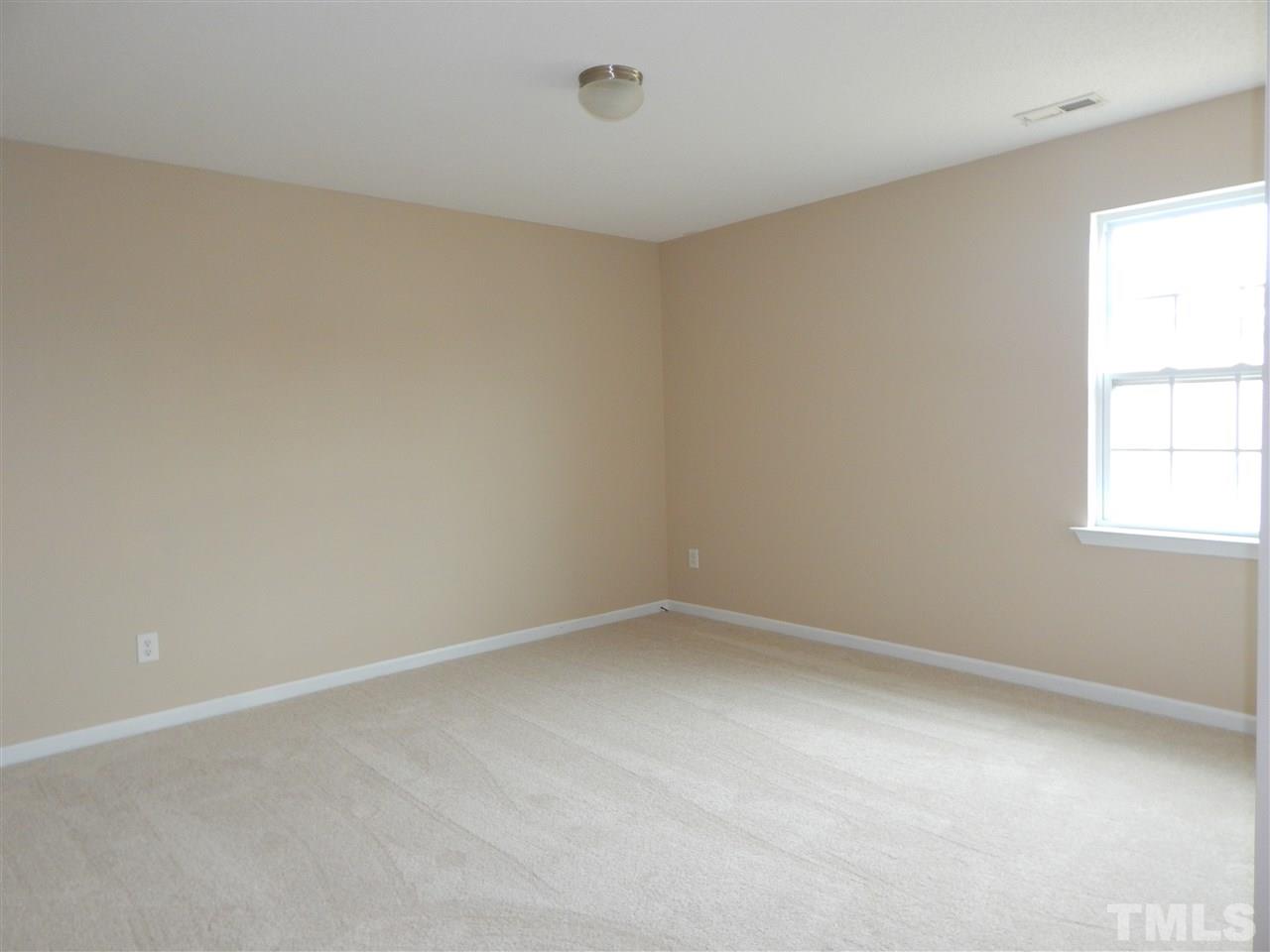 4808 Cutstone Court Raleigh, NC 27610 - Photo 11 of 14 an empty room with a window
