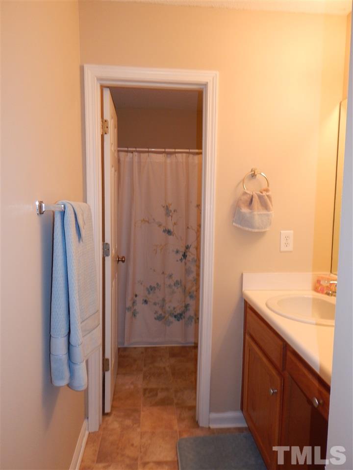 4808 Cutstone Court Raleigh, NC 27610 - Photo 14 of 14 a bathroom with a sink and a shower