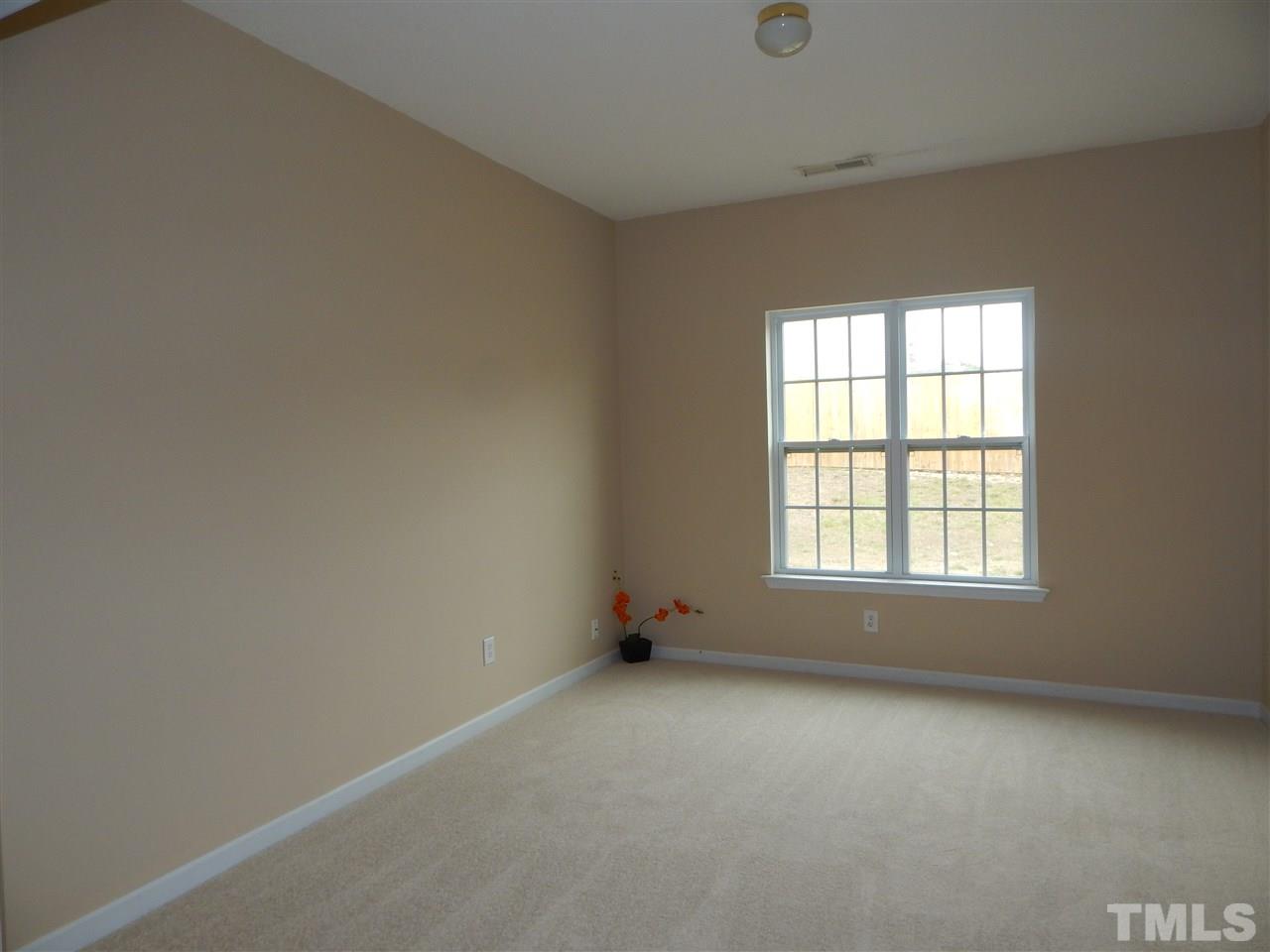 4808 Cutstone Court Raleigh, NC 27610 - Photo 3 of 14 an empty room with a window