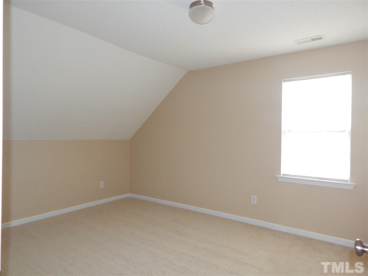 4808 Cutstone Court Raleigh, NC 27610 - Photo 10 of 14 an empty room with a window