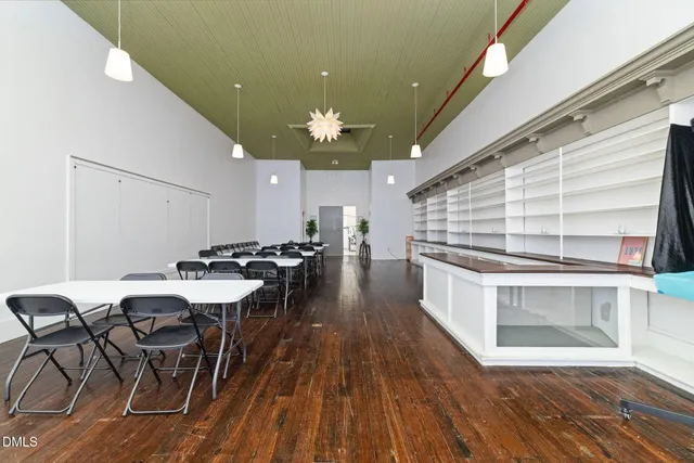 a view of a dining hall with furniture and wooden floor