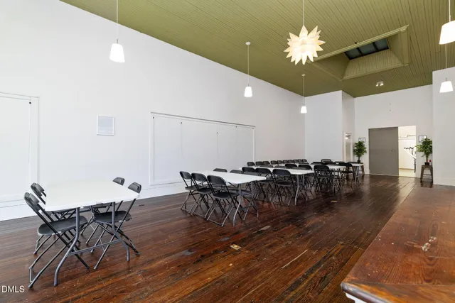 a room with a walk in closet a mirror and a clock on the wall