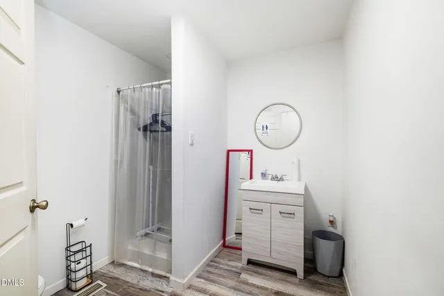 a view of entryway and hall with wooden floor