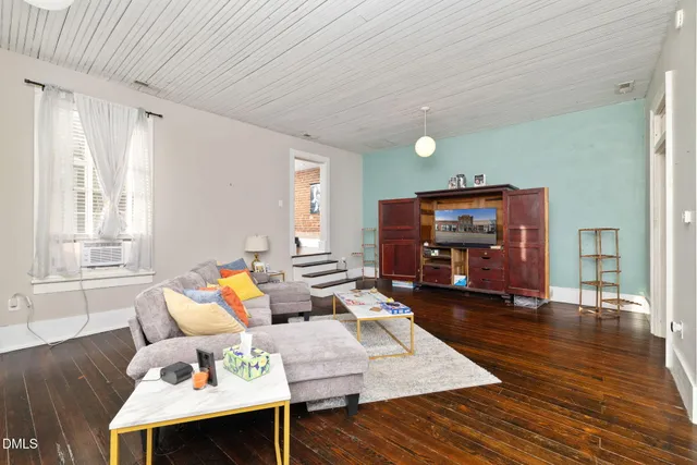 a kitchen with stainless steel appliances hardwood floor and a sink
