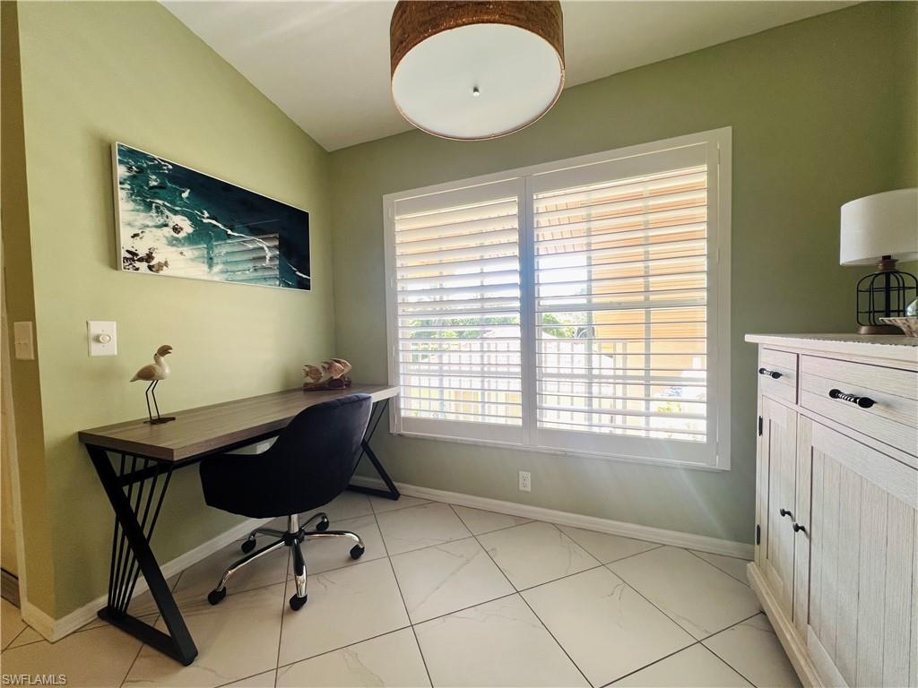 8073 Panther Trail, Unit 1404 Naples, FL 34113 - Photo 6 of 29 a view of a workspace with furniture and a window