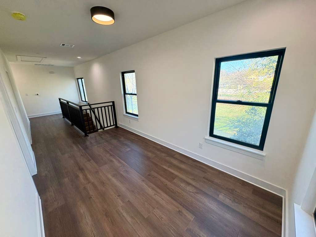 10209 Gail Road Austin, TX 78748 - Photo 16 of 38 Empty room featuring dark wood-style floors and recessed lighting