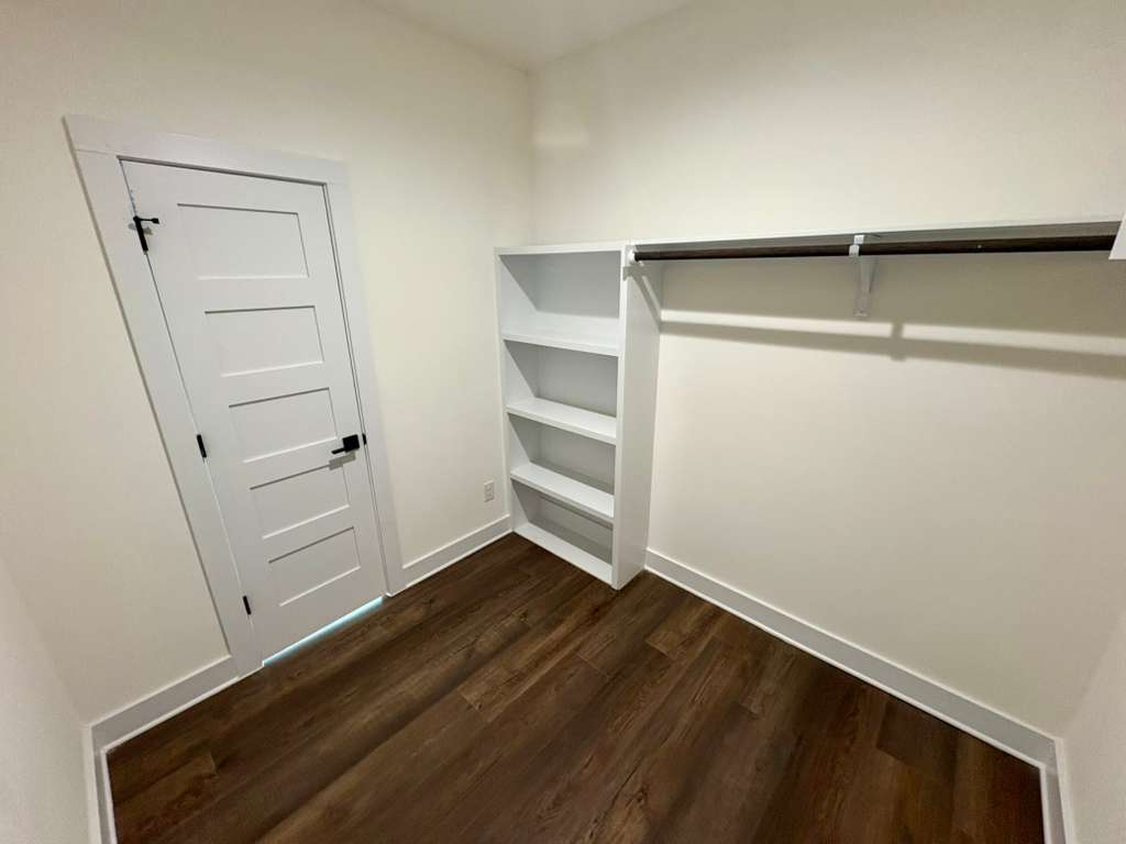 10209 Gail Road Austin, TX 78748 - Photo 26 of 38 Walk in closet featuring dark wood finished floors