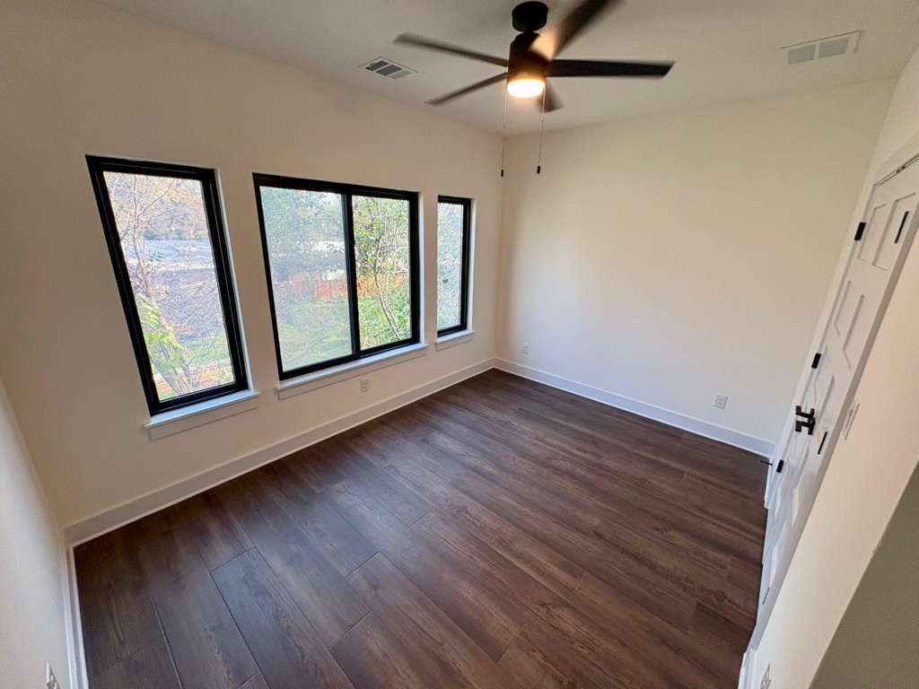 10209 Gail Road Austin, TX 78748 - Photo 28 of 38 Unfurnished bedroom featuring dark wood-style floors and ceiling fan