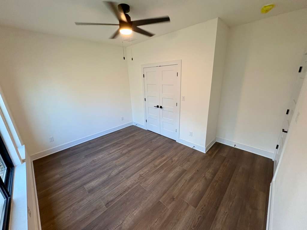 10209 Gail Road Austin, TX 78748 - Photo 30 of 38 Unfurnished bedroom with dark wood-style flooring, a closet, and ceiling fan