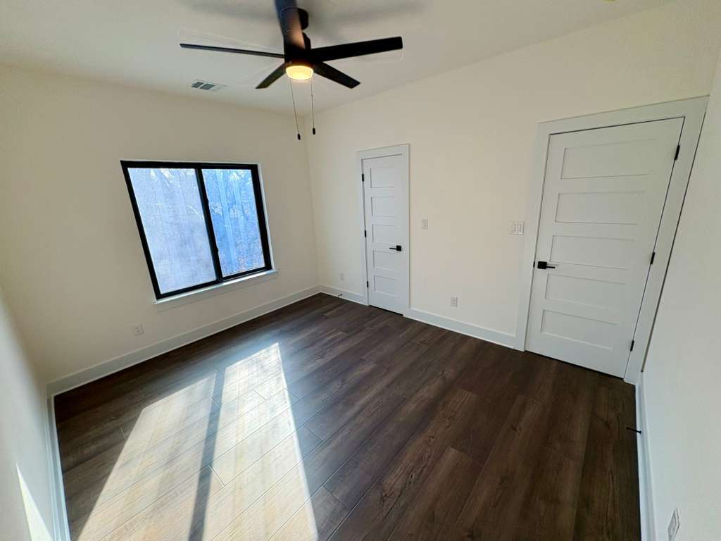 10209 Gail Road Austin, TX 78748 - Photo 32 of 38 Unfurnished bedroom with dark wood-style floors and a ceiling fan