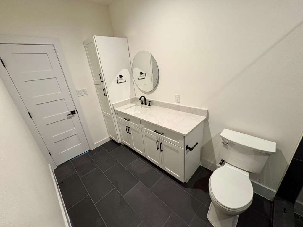 10209 Gail Road Austin, TX 78748 - Photo 33 of 38 Bathroom with vanity and dark tile patterned floors
