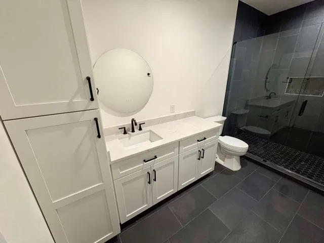 a bathroom with a sink toilet and shower
