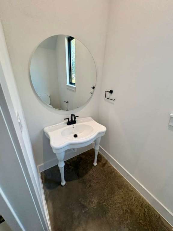 10209 Gail Road Austin, TX 78748 - Photo 36 of 38 Bathroom with baseboards and concrete flooring