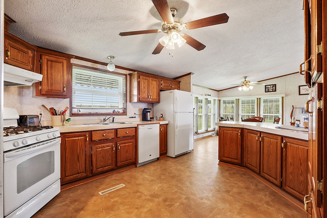 29857 South Klemme Road Beecher, IL 60401 - Photo 7 of 20 a kitchen with a stove a sink and a refrigerator