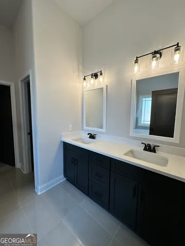a bathroom with a double vanity sink and mirror