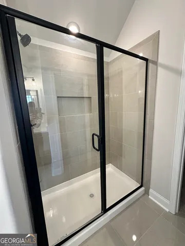a bathroom with a glass shower door