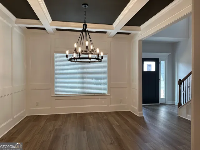 a view of empty room with wooden floor and window
