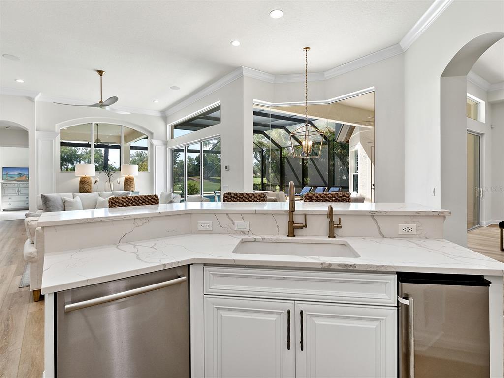 7431 Greystone Street Lakewood Ranch, FL 34202 - Photo 28 of 85 a kitchen with a sink and a refrigerator