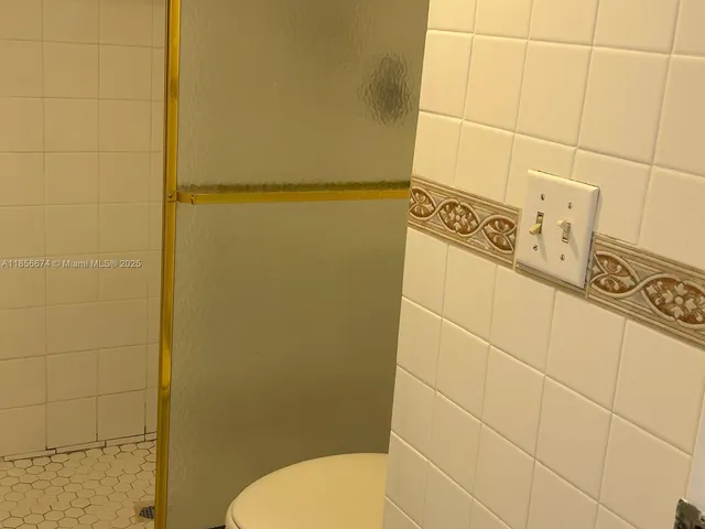 a bathroom with a shower and a sink