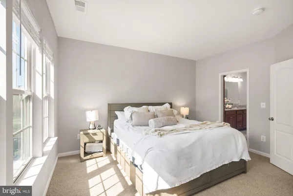 a bedroom with a bed and a large window