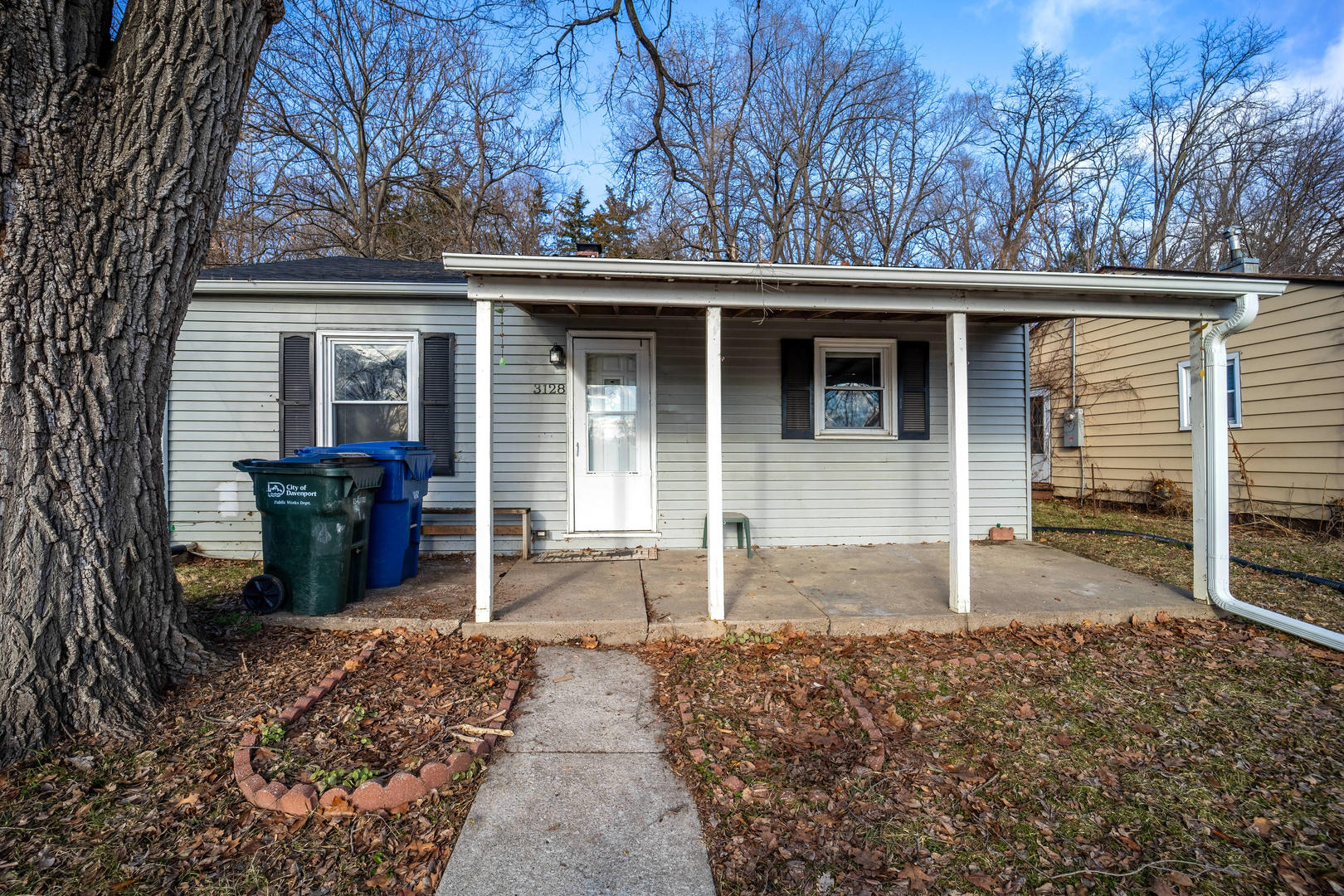 3128 Indian Road Davenport, IA 52802 - Photo 2 of 23 a view of a house with a large window and wooden fence