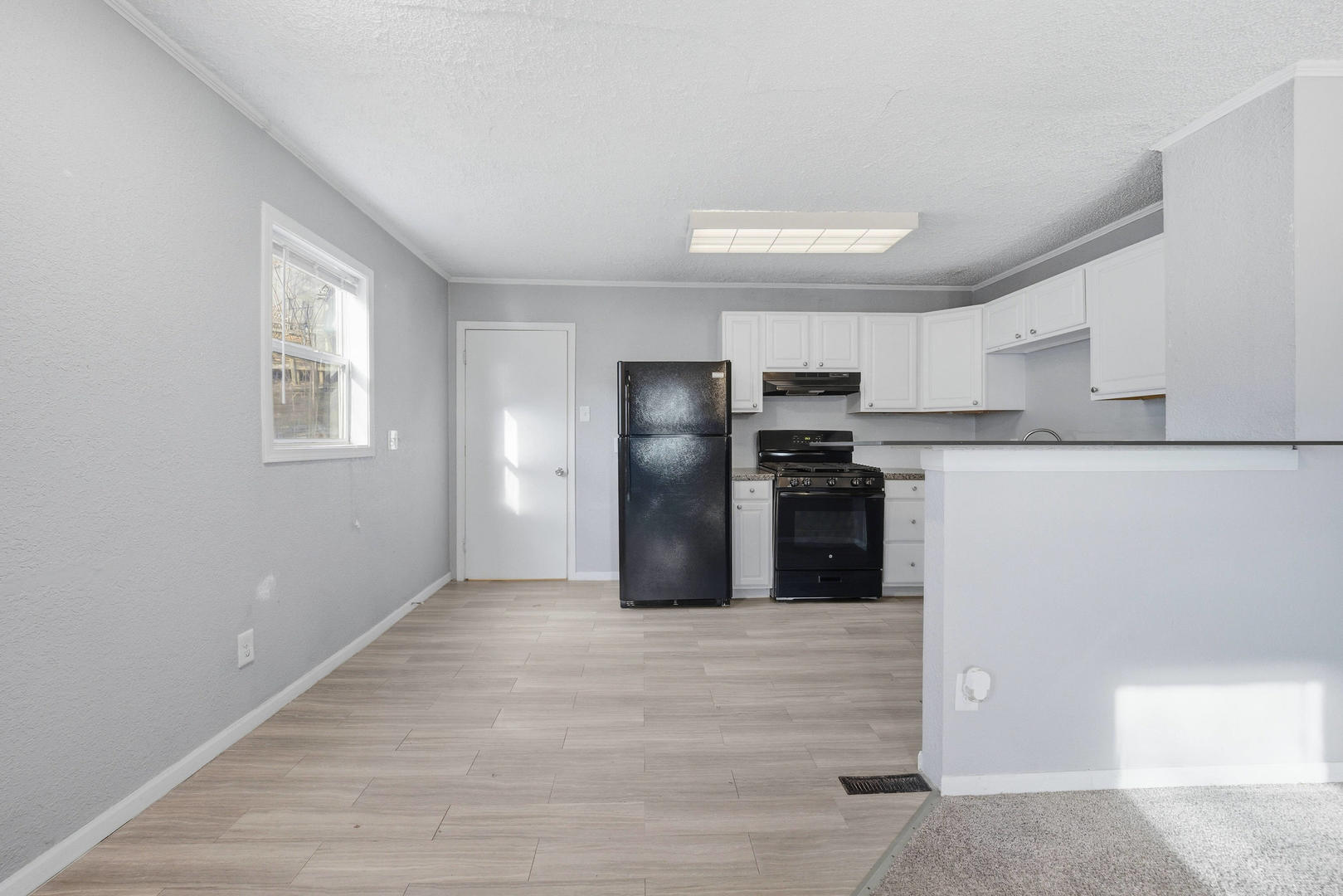 3128 Indian Road Davenport, IA 52802 - Photo 6 of 23 a kitchen with refrigerator and cabinets