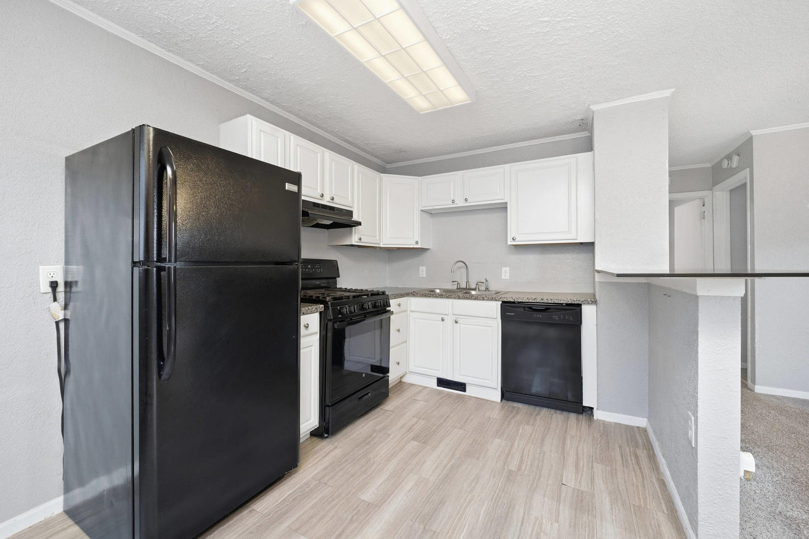 3128 Indian Road Davenport, IA 52802 - Photo 8 of 23 a kitchen with a refrigerator and a sink