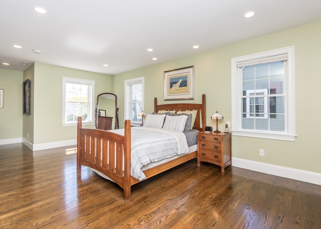 128 Church Street, Unit 2 Waltham, MA 02452 - Photo 27 of 41 a bedroom with a bed and wooden floor