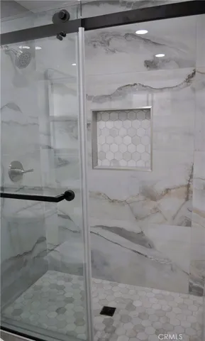 a bathroom with a glass shower door