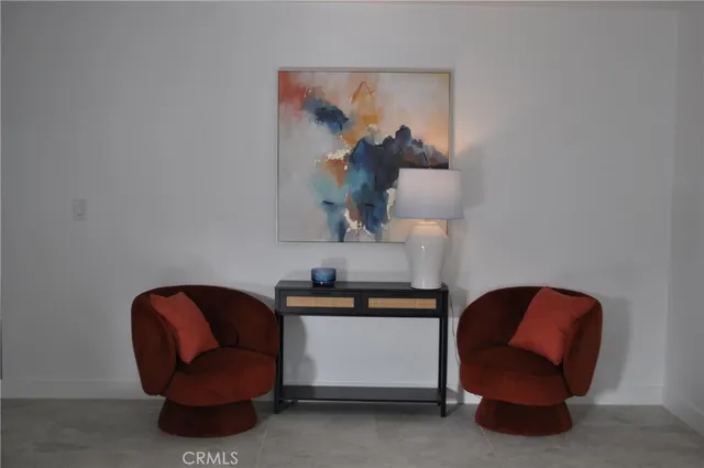 a living room with furniture and a mirror