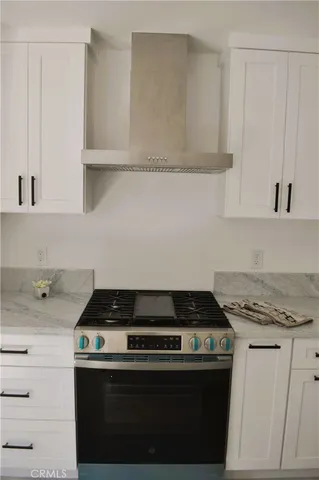 a stove top oven sitting inside of a kitchen