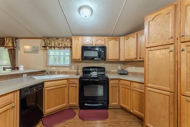 a kitchen with a sink appliances and cabinets