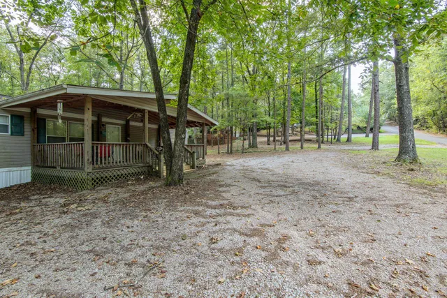 a view of a barn in the middle of a yard