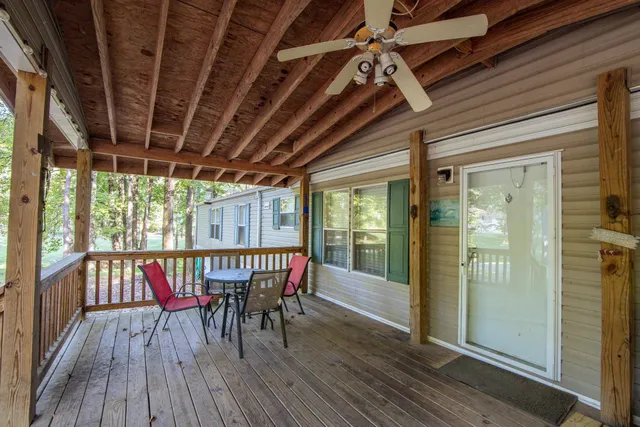 a view of a roof deck with table and chairs with wooden floor