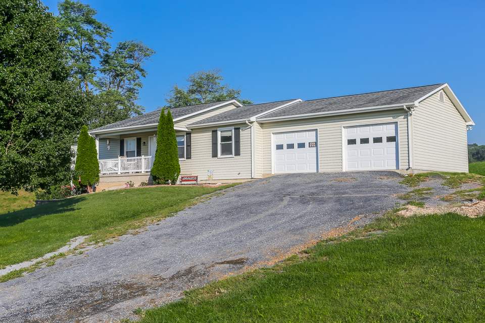 5296 Briery Branch Road Dayton, VA 22821 - Photo 2 of 45 a front view of a house with a yard and garage