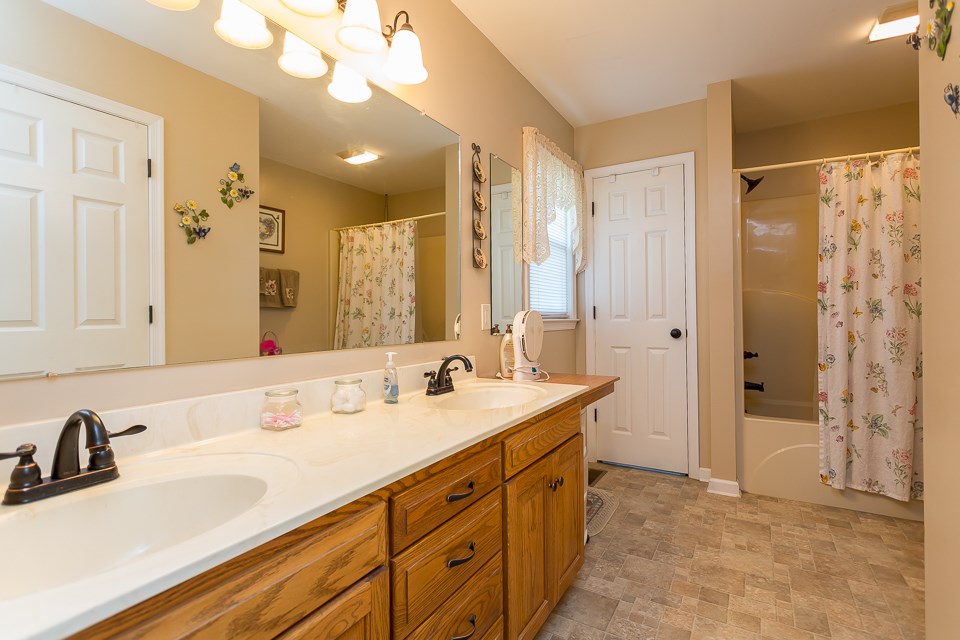 5296 Briery Branch Road Dayton, VA 22821 - Photo 23 of 45 a bathroom with a sink double vanity and a mirror