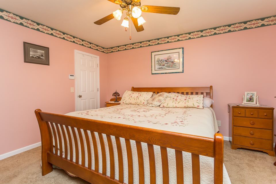 5296 Briery Branch Road Dayton, VA 22821 - Photo 26 of 45 a bedroom with a bed and a chandelier