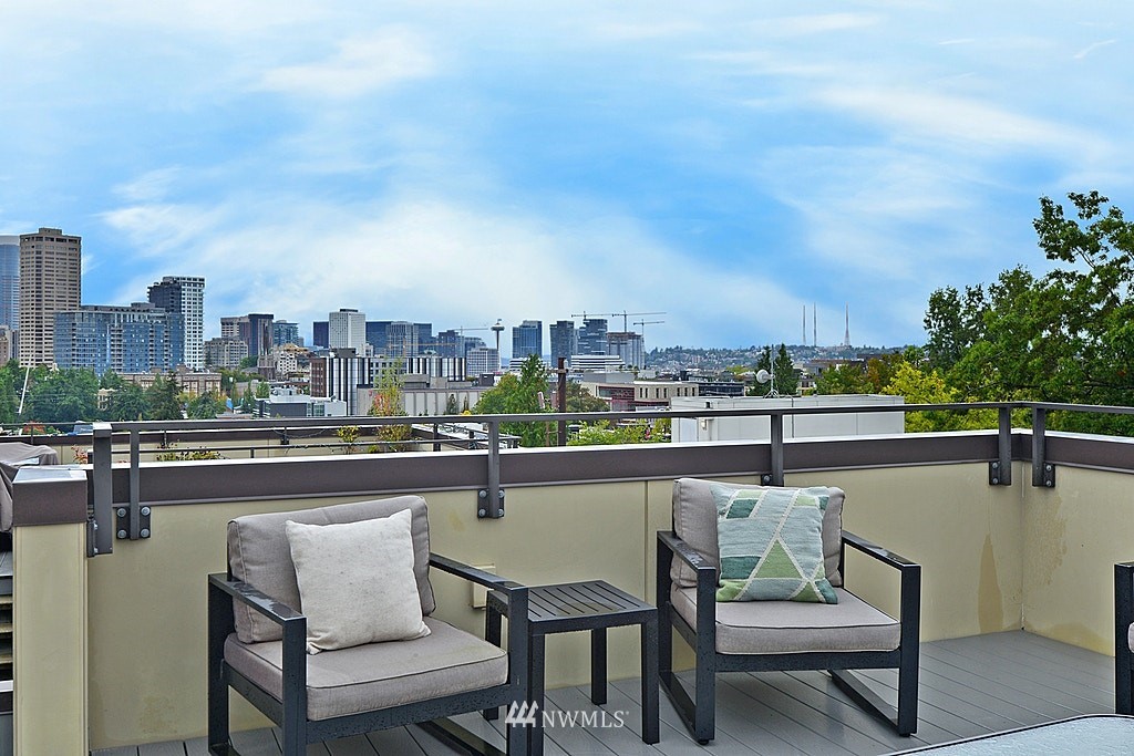 933 16th Avenue, Unit A Seattle, WA 98122 - Photo 2 of 19 a swimming pool with outdoor seating and city view
