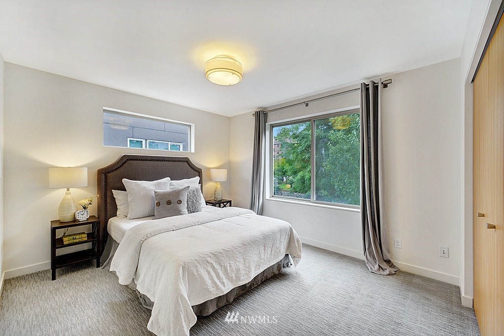 933 16th Avenue, Unit A Seattle, WA 98122 - Photo 11 of 19 a bedroom with a bed and a window