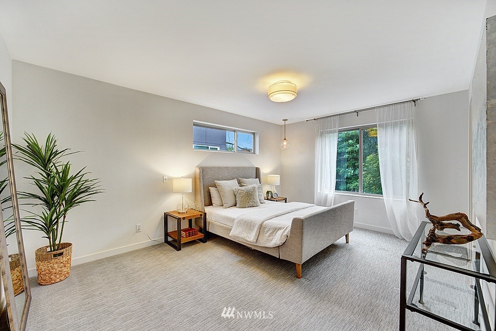 933 16th Avenue, Unit A Seattle, WA 98122 - Photo 13 of 19 a bedroom with a bed and window