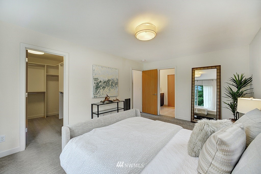 933 16th Avenue, Unit A Seattle, WA 98122 - Photo 14 of 19 a bedroom with a bed and a large mirror