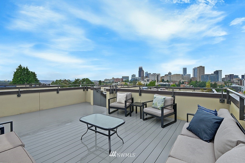 933 16th Avenue, Unit A Seattle, WA 98122 - Photo 19 of 19 a terrace with outdoor seating and city view