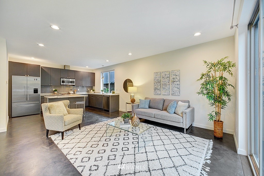 933 16th Avenue, Unit A Seattle, WA 98122 - Photo 6 of 19 a living room with furniture and a large window