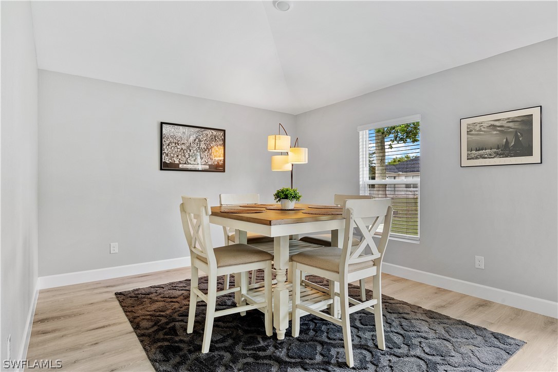 16582 Becasse Drive Punta Gorda, FL 33955 - Photo 12 of 32 a view of a dining room with furniture and wooden floor