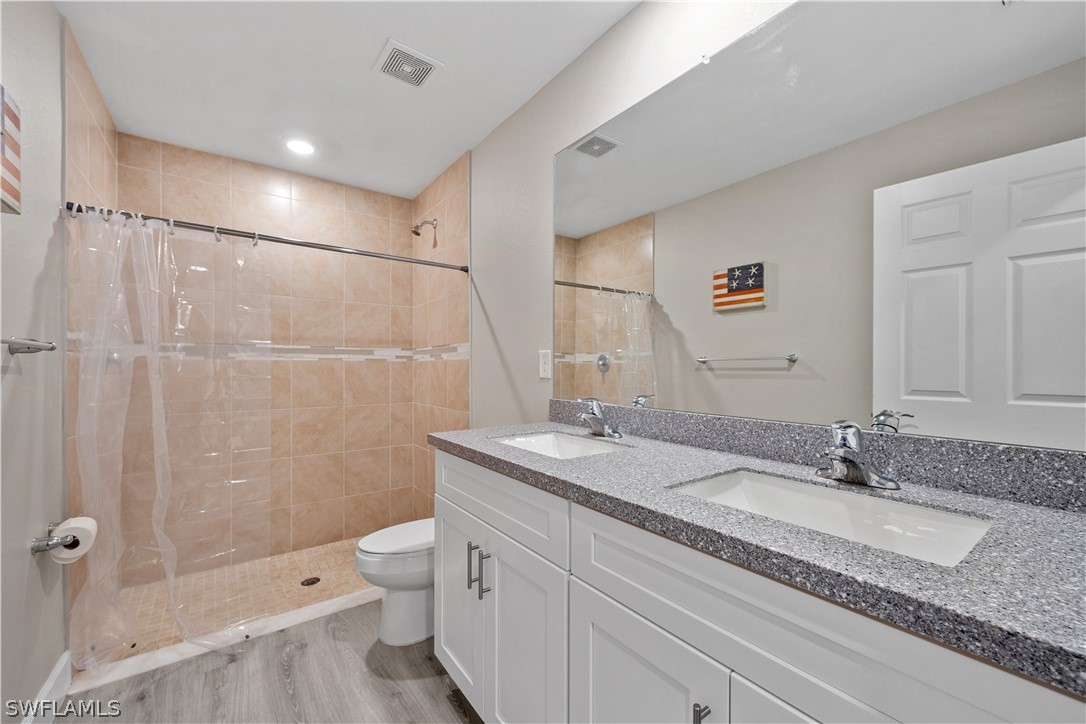 16582 Becasse Drive Punta Gorda, FL 33955 - Photo 16 of 32 a bathroom with a granite countertop sink toilet and shower